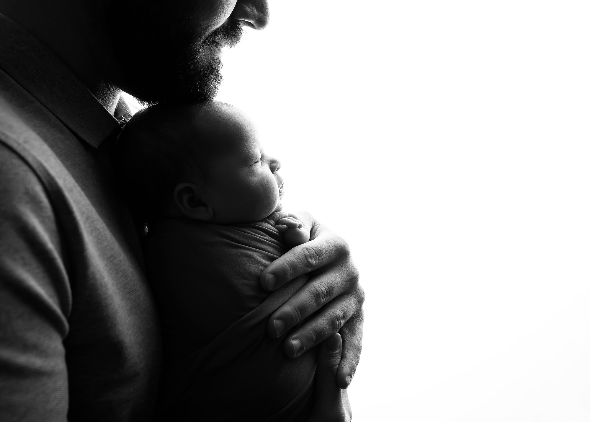 Dad holding newborn baby at their family photography session in Portlethen near Aberdeen with Sharon Nicholson Photography